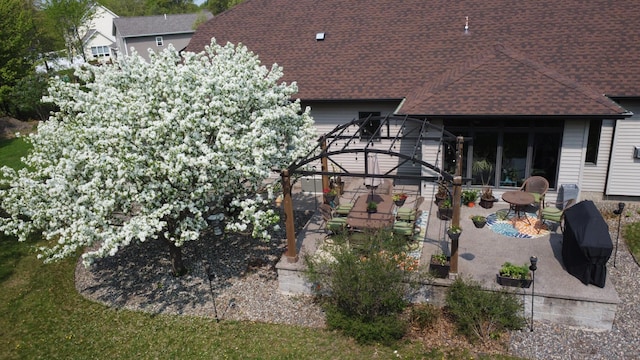 6203 Fairfax Ct, Baxter, MN 56425 - back of house featuring a patio area, roof with shingles, and glass enclosure