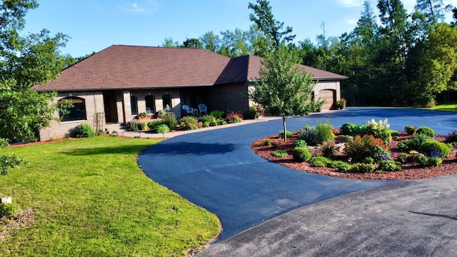 6203 Fairfax Ct, Baxter, MN 56425 - view of front of home with curved driveway, a front yard, a garage, and brick siding