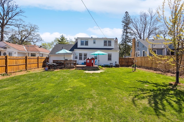 rear view of property with a deck and roof with shingles