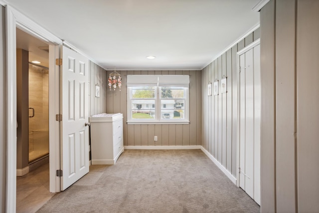 unfurnished bedroom featuring baseboards, light carpet, and ornamental molding