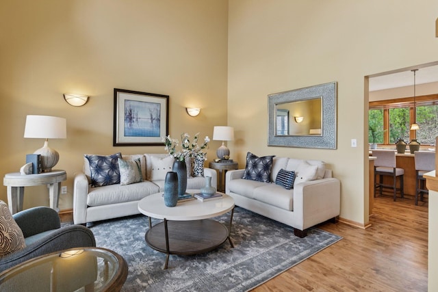 4633 Stonecliffe Dr, Eagan, MN 55122 - living room with wood finished floors, baseboards, and a towering ceiling