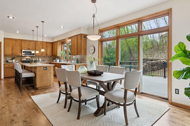 4633 Stonecliffe Dr, Eagan, MN 55122 - dining area with healthy amount of natural light, light wood-style floors, recessed lighting, and baseboards
