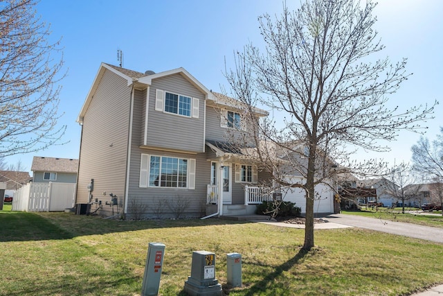 view of front of home with cooling unit, driveway, and a front lawn