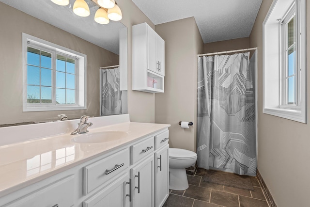 full bath with stone finish floor, vanity, baseboards, toilet, and an inviting chandelier