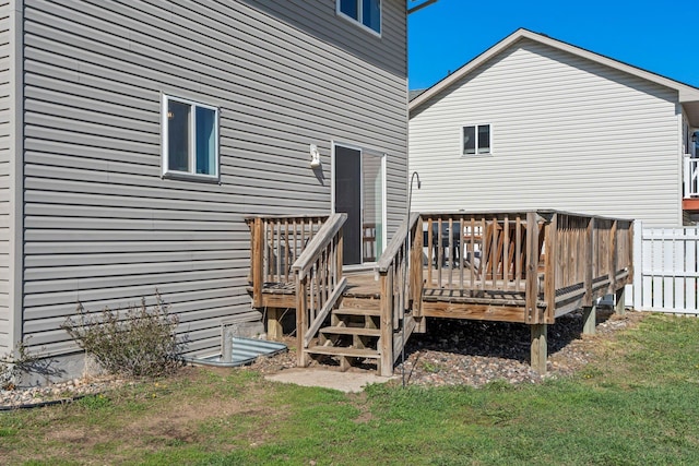 exterior space with a lawn, fence, and a wooden deck