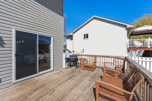 deck with a gazebo and area for grilling