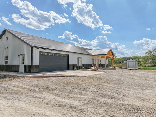 20462 Little Alps Rd NW, Evansville, MN 56326 - view of front of home with a shed, an outdoor structure, metal roof, and driveway