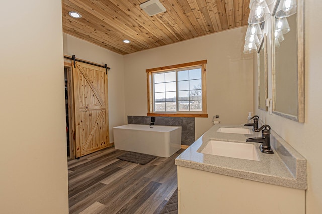 20462 Little Alps Rd NW, Evansville, MN 56326 - full bath featuring a soaking tub, recessed lighting, wood finished floors, wood ceiling, and double vanity