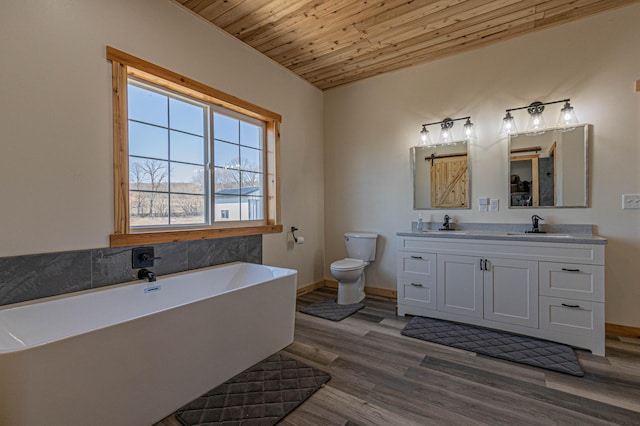 20462 Little Alps Rd NW, Evansville, MN 56326 - bathroom featuring toilet, wood ceiling, a soaking tub, double vanity, and wood finished floors