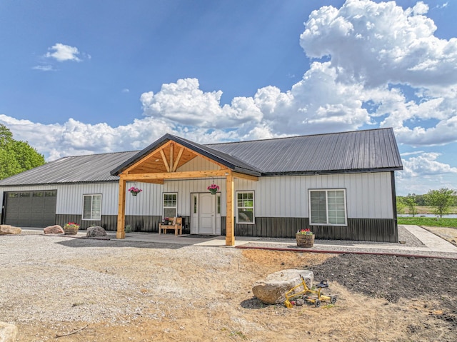 20462 Little Alps Rd NW, Evansville, MN 56326 - modern inspired farmhouse with metal roof, a garage, and board and batten siding