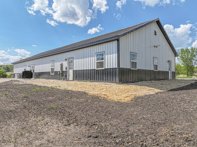 20462 Little Alps Rd NW, Evansville, MN 56326 - view of side of home featuring board and batten siding, metal roof, and an outbuilding