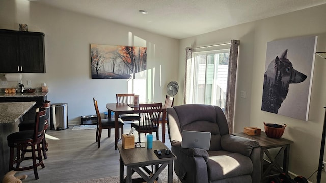 living area with light wood-style floors and baseboards