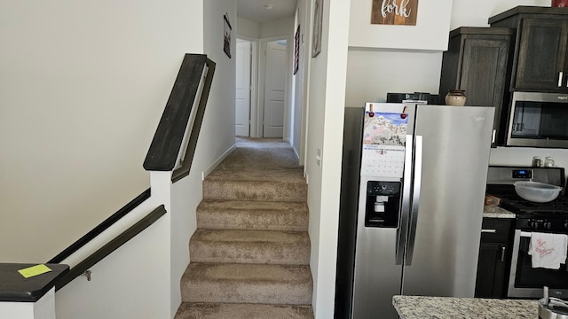 stairs with baseboards and carpet