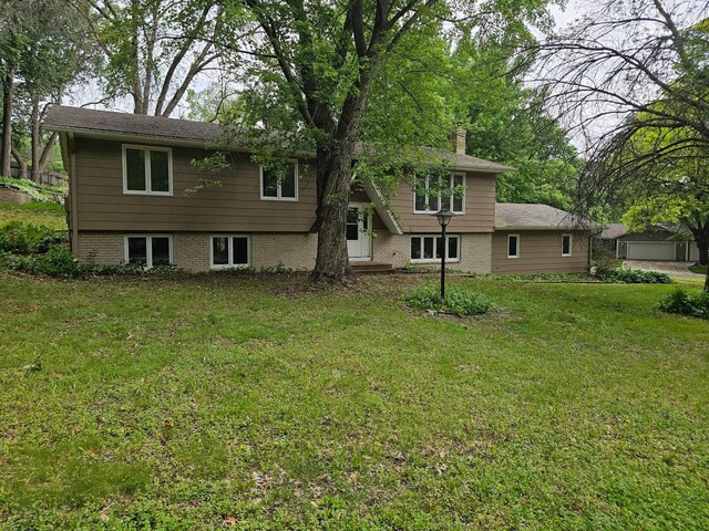 13100 Thomas Ave S, Burnsville, MN 55337 - rear view of house featuring a chimney, a yard, and brick siding