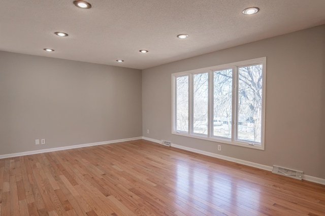 13100 Thomas Ave S, Burnsville, MN 55337 - unfurnished room with light wood-style flooring, recessed lighting, and a textured ceiling