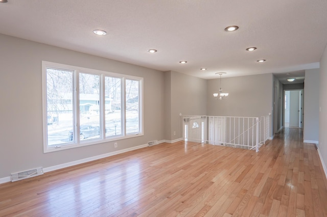 13100 Thomas Ave S, Burnsville, MN 55337 - unfurnished room with a chandelier, recessed lighting, and light wood-style floors