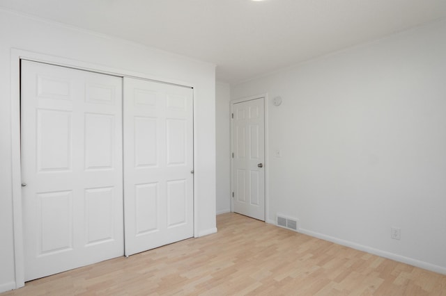 13100 Thomas Ave S, Burnsville, MN 55337 - unfurnished bedroom with light wood-style floors, a closet, and crown molding