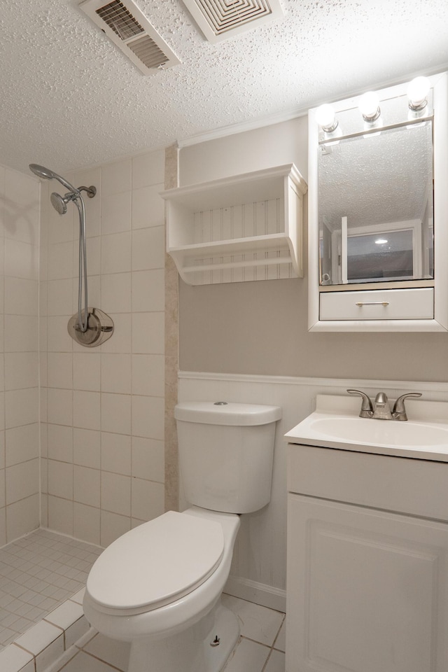 13100 Thomas Ave S, Burnsville, MN 55337 - bathroom with a textured ceiling, tiled shower, vanity, and tile patterned floors