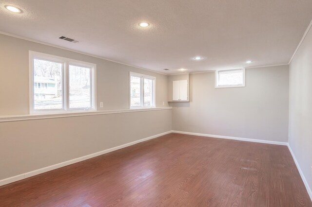 13100 Thomas Ave S, Burnsville, MN 55337 - empty room with crown molding, recessed lighting, and dark wood-style flooring