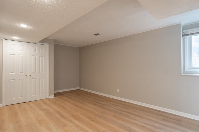 13100 Thomas Ave S, Burnsville, MN 55337 - unfurnished bedroom with light wood-style flooring, recessed lighting, ornamental molding, a textured ceiling, and a closet
