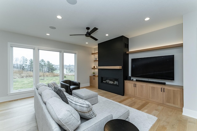 3251 Century Ridge Pl NE, Rochester, MN 55906 - living room with plenty of natural light, light wood-style flooring, a fireplace, ceiling fan, and recessed lighting