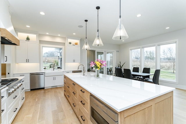 3251 Century Ridge Pl NE, Rochester, MN 55906 - kitchen with stainless steel appliances, custom range hood, recessed lighting, light wood finished floors, and plenty of natural light