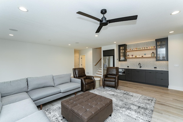 3251 Century Ridge Pl NE, Rochester, MN 55906 - living area with wet bar, light wood-style flooring, recessed lighting, ceiling fan, and stairway