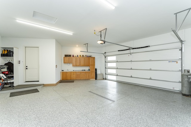 3251 Century Ridge Pl NE, Rochester, MN 55906 - garage with a garage door opener and baseboards
