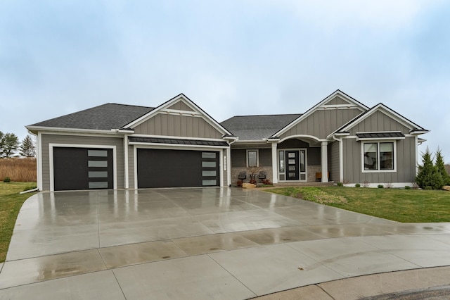 3251 Century Ridge Pl NE, Rochester, MN 55906 - view of front of house with board and batten siding, a garage, a front yard, driveway, and a shingled roof