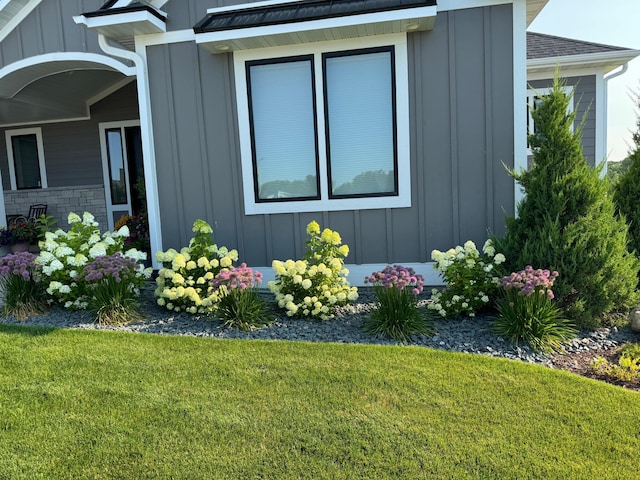 3251 Century Ridge Pl NE, Rochester, MN 55906 - view of side of home with board and batten siding and a lawn