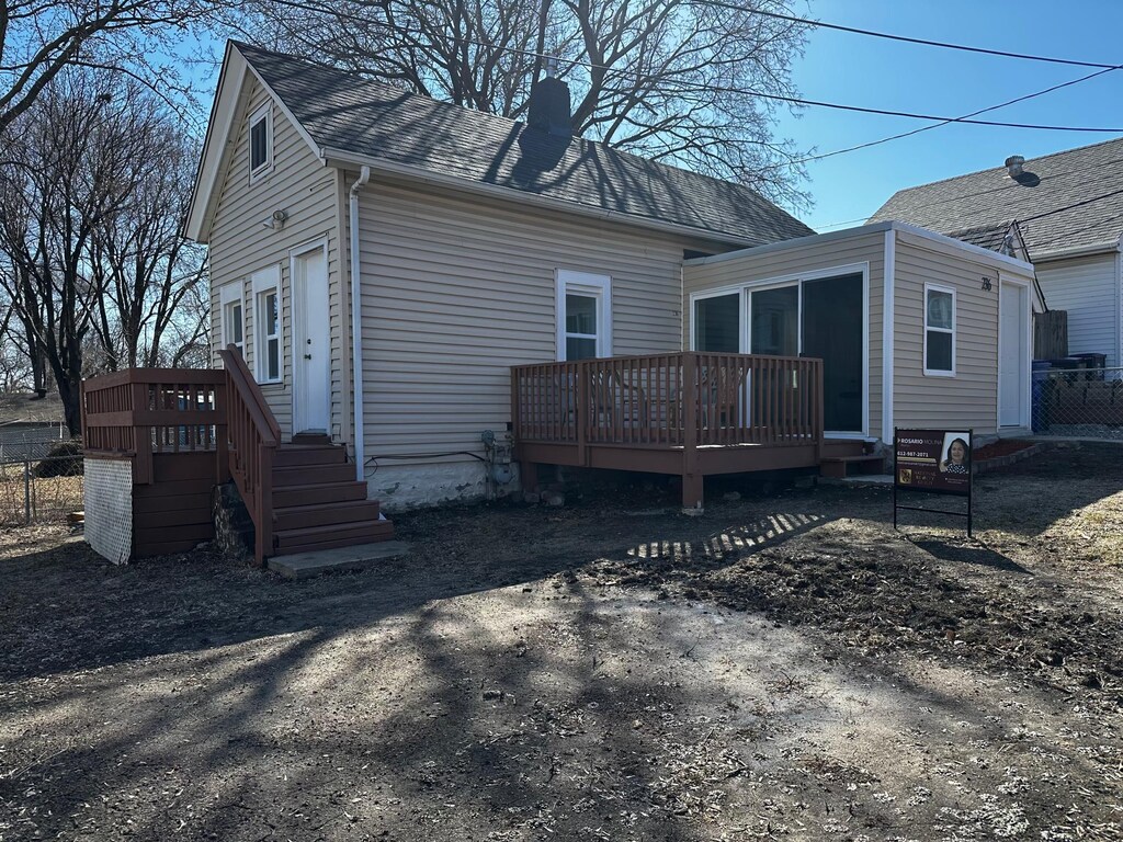 236 Lawson Ave W, Saint Paul, MN 55117 - rear view of house featuring roof with shingles, a chimney, fence, and a deck