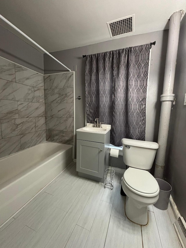 1017 Prairie St, Lake City, MN 55041 - full bath with visible vents, bathtub / shower combination, toilet, vanity, and wood tiled floor