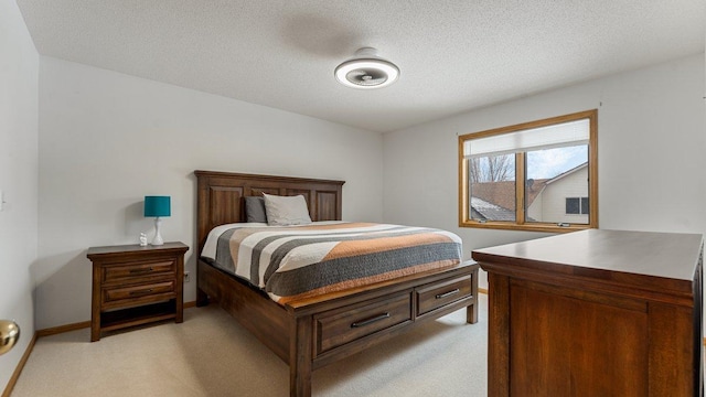 bedroom with a textured ceiling, baseboards, and light colored carpet