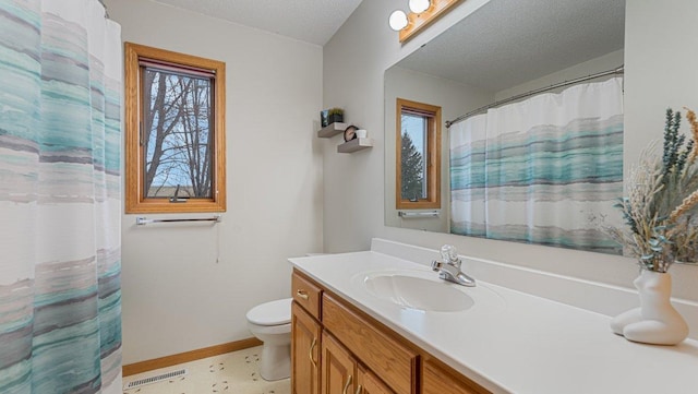 full bath with visible vents, a healthy amount of sunlight, toilet, and vanity