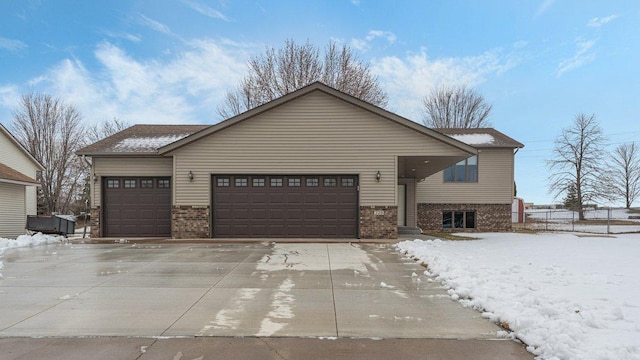 view of front of home with brick siding, an attached garage, and driveway