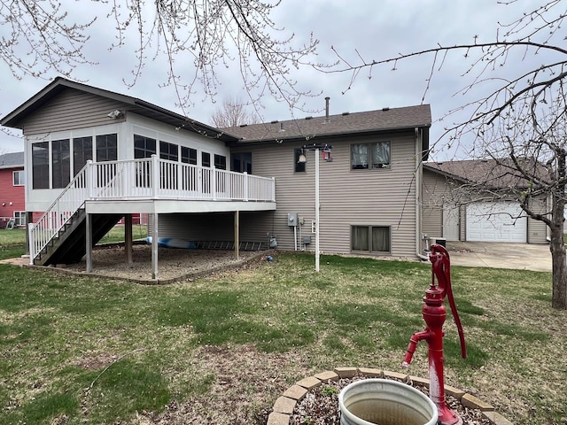 back of property with a sunroom, a yard, stairs, and a deck