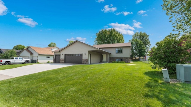 328 5th Ave S, Sartell, MN 56377 - view of front of property with concrete driveway, a garage, and a front lawn