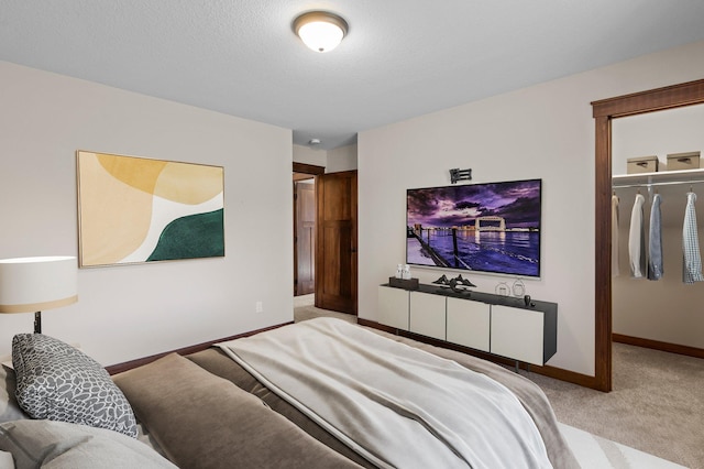27290 Petes Hill Trl, Elko New Market, MN 55020 - carpeted bedroom with a textured ceiling, a closet, baseboards, and a walk in closet