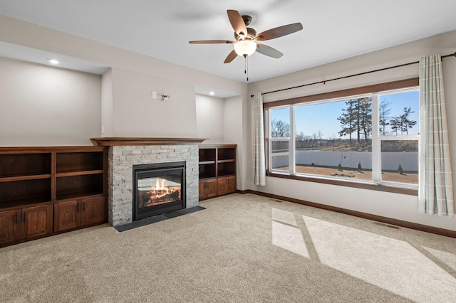 27290 Petes Hill Trl, Elko New Market, MN 55020 - unfurnished living room featuring visible vents, a ceiling fan, carpet, and a fireplace