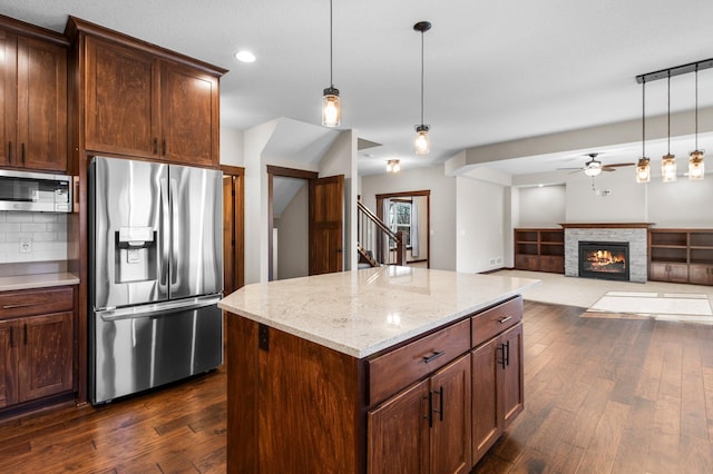 27290 Petes Hill Trl, Elko New Market, MN 55020 - kitchen with tasteful backsplash, dark wood-style floors, ceiling fan, stainless steel appliances, and pendant lighting
