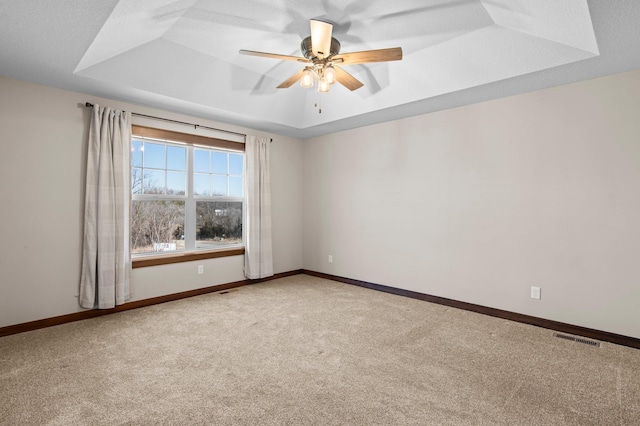 27290 Petes Hill Trl, Elko New Market, MN 55020 - carpeted empty room with a tray ceiling, ceiling fan, baseboards, and visible vents