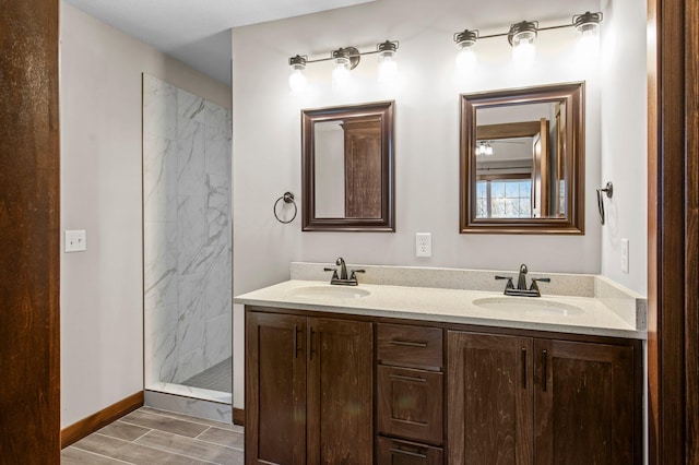 27290 Petes Hill Trl, Elko New Market, MN 55020 - full bath with double vanity, baseboards, a sink, and a marble finish shower