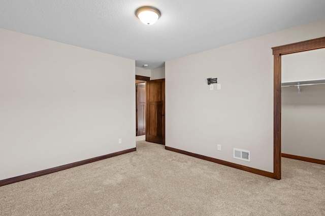 27290 Petes Hill Trl, Elko New Market, MN 55020 - unfurnished bedroom with visible vents, baseboards, a walk in closet, and carpet floors