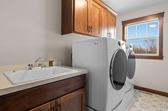 27290 Petes Hill Trl, Elko New Market, MN 55020 - laundry room with baseboards, a sink, washing machine and clothes dryer, and cabinet space