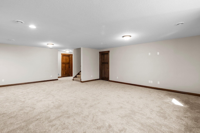 27290 Petes Hill Trl, Elko New Market, MN 55020 - unfurnished room featuring light carpet, stairs, baseboards, and a textured ceiling