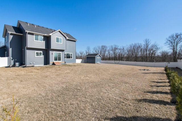 27290 Petes Hill Trl, Elko New Market, MN 55020 - rear view of house with an outdoor structure, a storage shed, a fenced backyard, central AC, and a yard