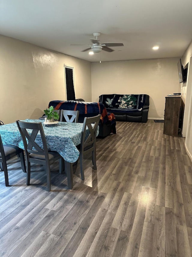 dining space featuring dark wood-type flooring and a ceiling fan