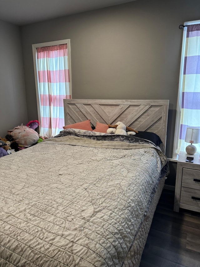 bedroom with dark wood-type flooring