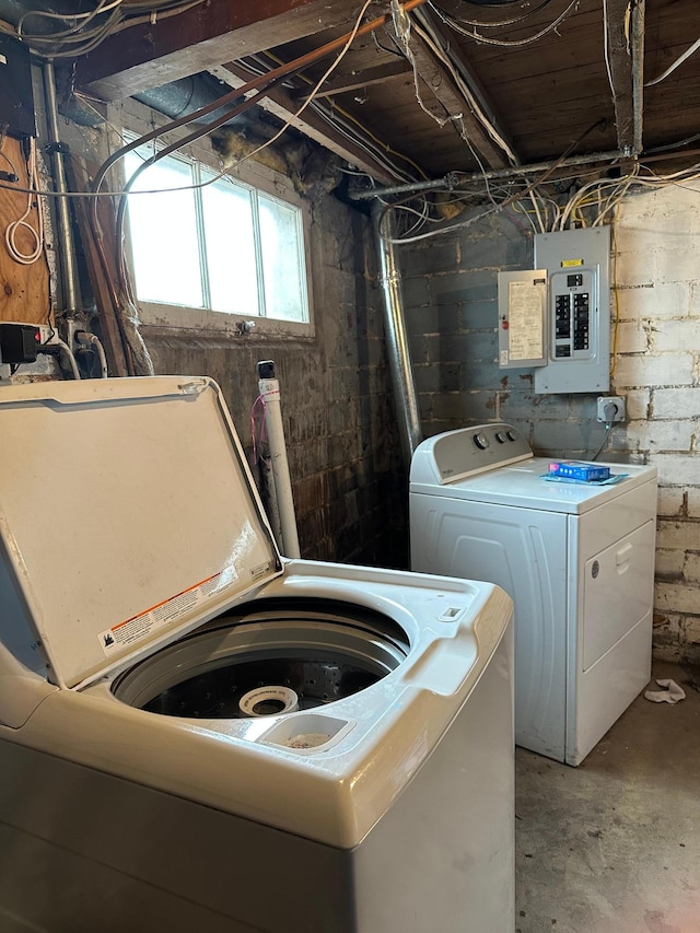 washroom featuring washing machine and clothes dryer, laundry area, and electric panel
