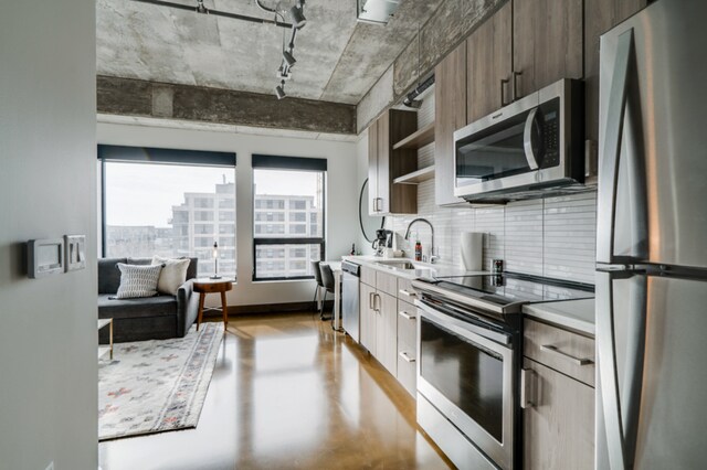 728 3rd St Unit 508, Minneapolis, MN 55401 - kitchen featuring light countertops, stainless steel appliances, tasteful backsplash, a sink, and open shelves